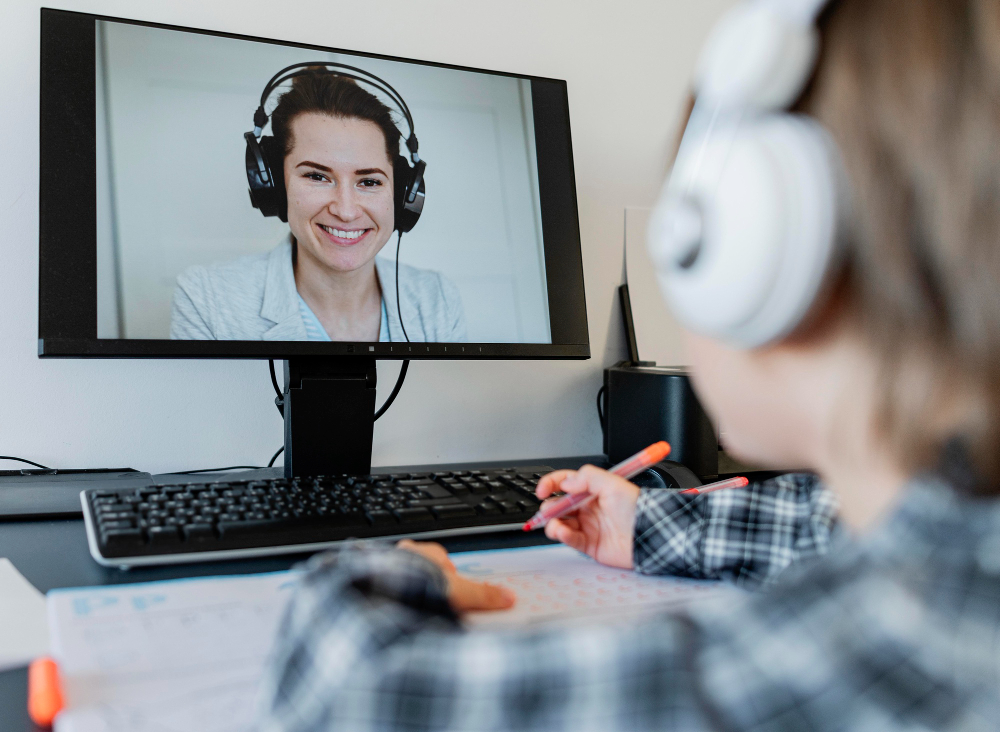 Student participating in an online lesson using a laptop.
