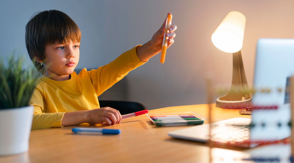 Student raising a hand while participating in a classroom learning activity.