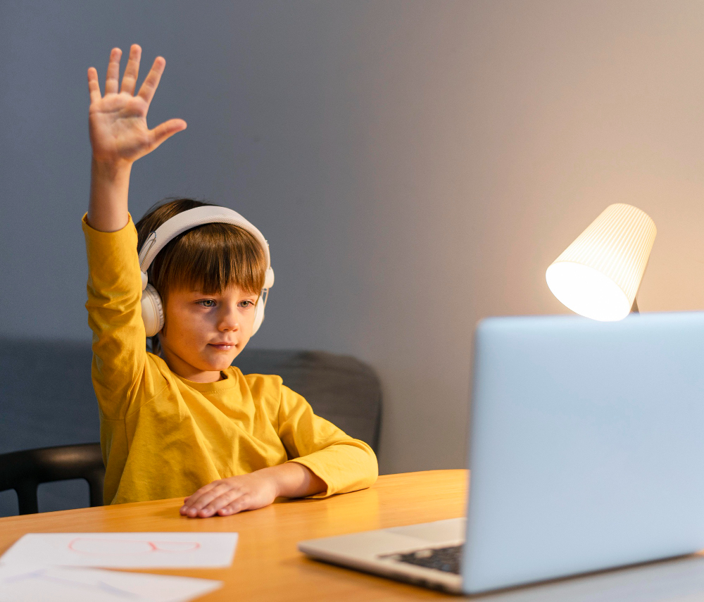 Student raising a hand while participating in an online class.