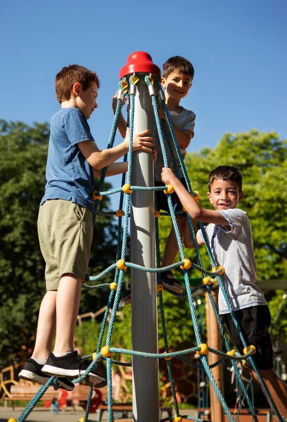 Student climbing a ladder with an instructor providing support during an outdoor activity at Horizon Academy.