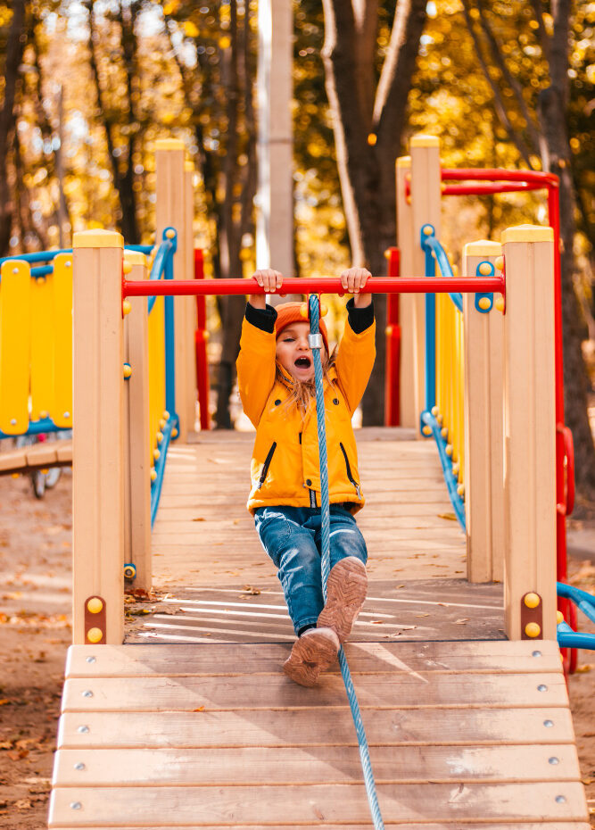 Student walking through colorful playground equipment at Horizon Academy.