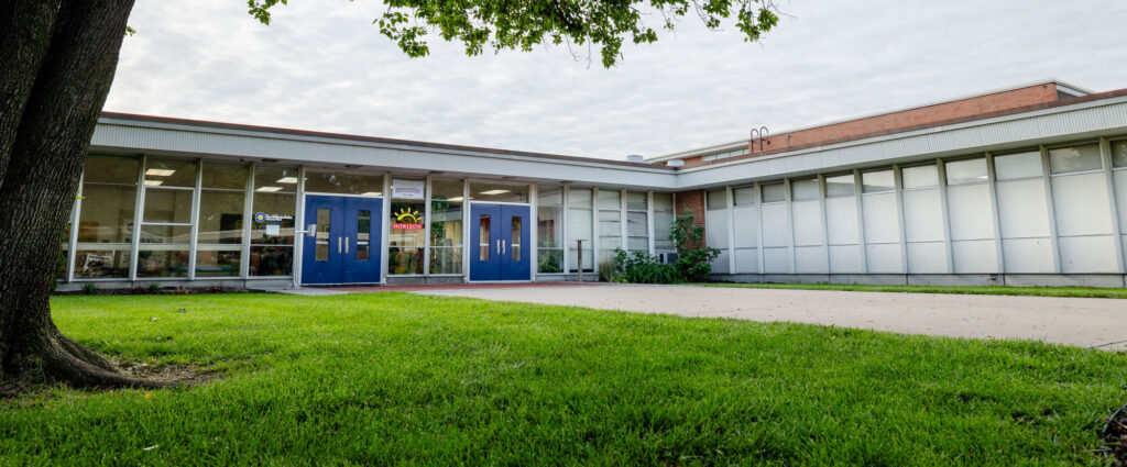 Exterior view of a Horizon Academy campus building with a grassy lawn.