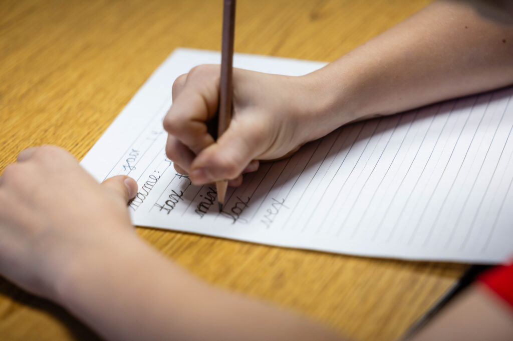 Student completing a handwriting assignment during class at Horizon Academy.