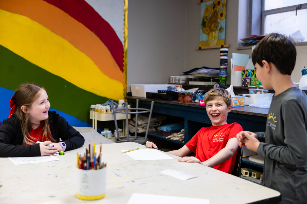 Student participating in a classroom learning activity at Horizon Academy.