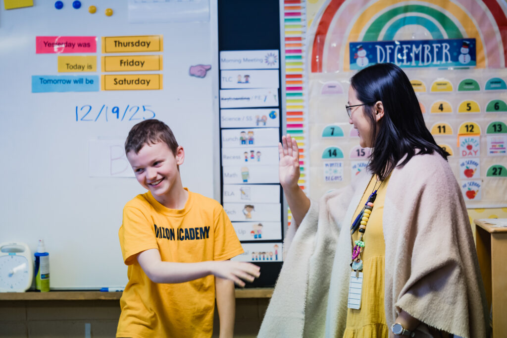Teacher talking with a Horizon Academy student during an individual classroom interaction.