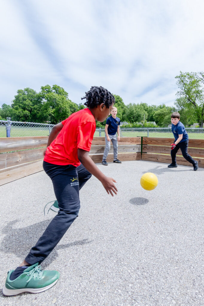 Intermediate school students participating in an outdoor physical activity.