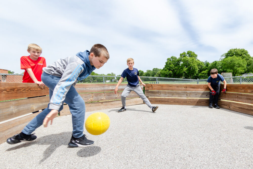 Intermediate school students playing an outdoor recreational game on the Horizon Academy campus.