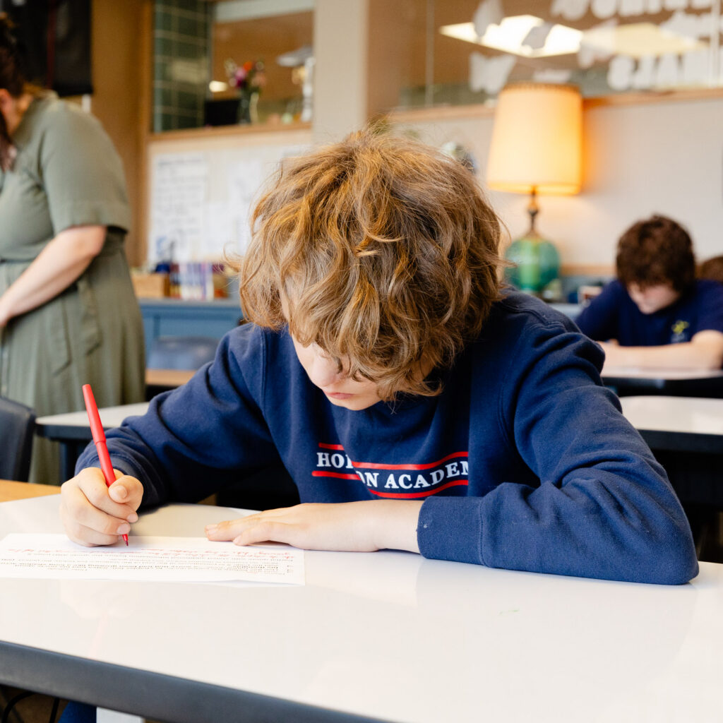 Intermediate school student focused on independent classroom work.