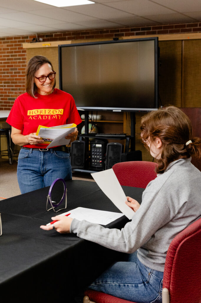 Participants completing a learning disability simulation exercise with guidance from an instructor.