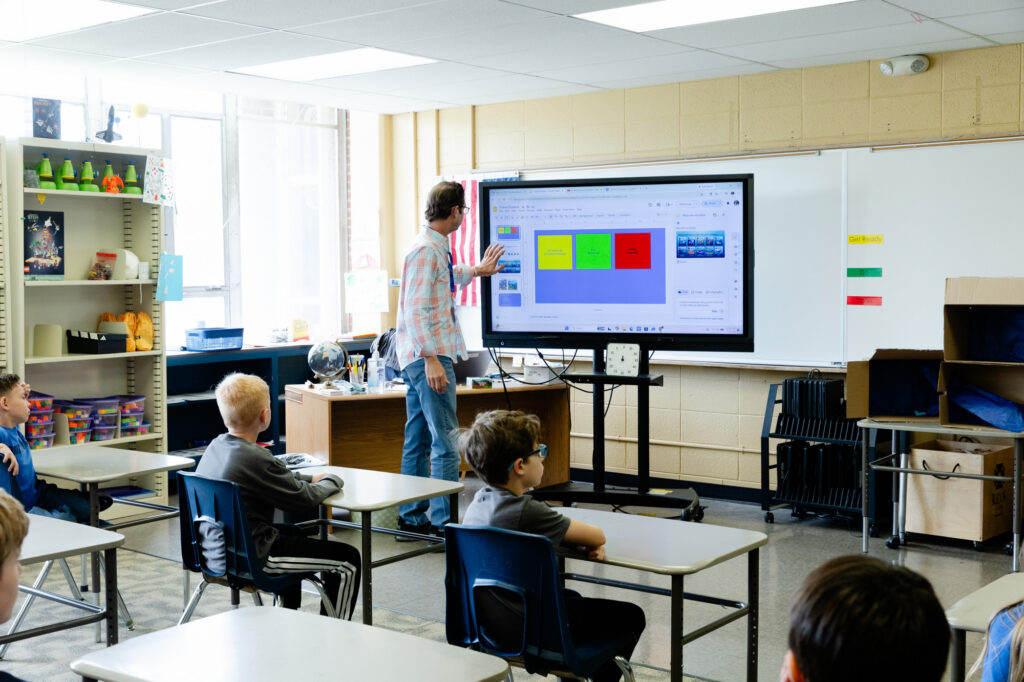 Students participating in a technology-enhanced lower school classroom lesson.
