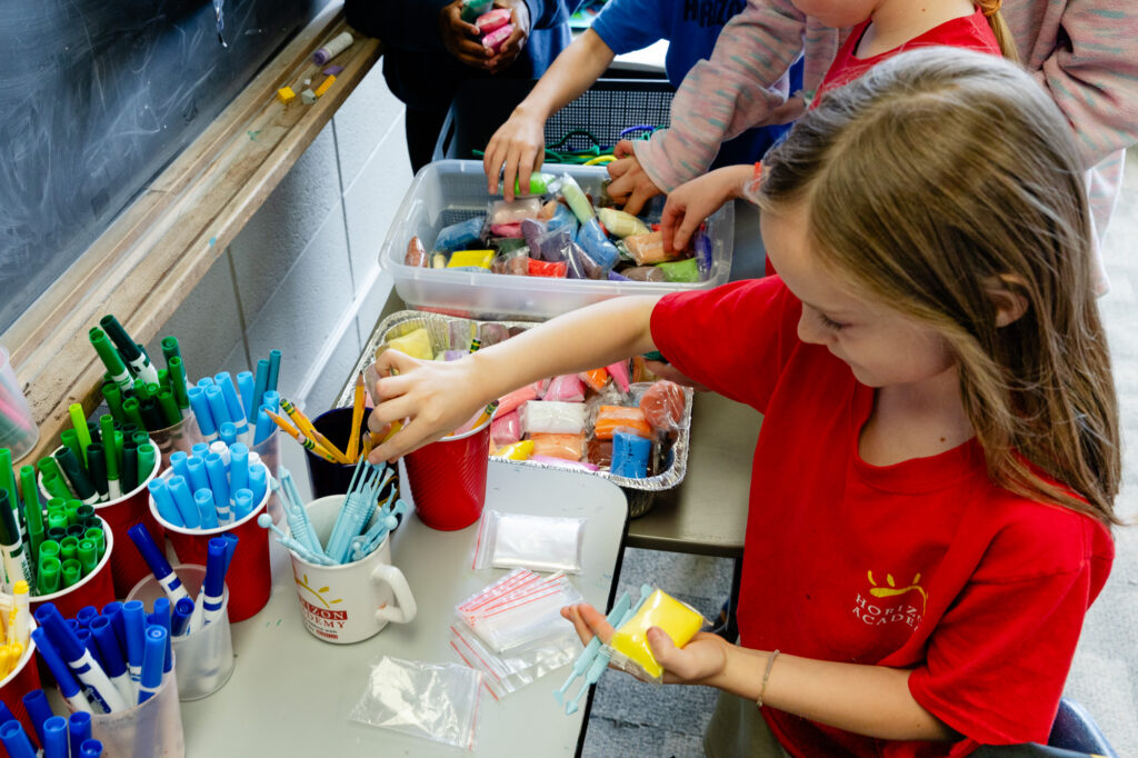 Lower school students creating projects during a hands-on classroom activity.