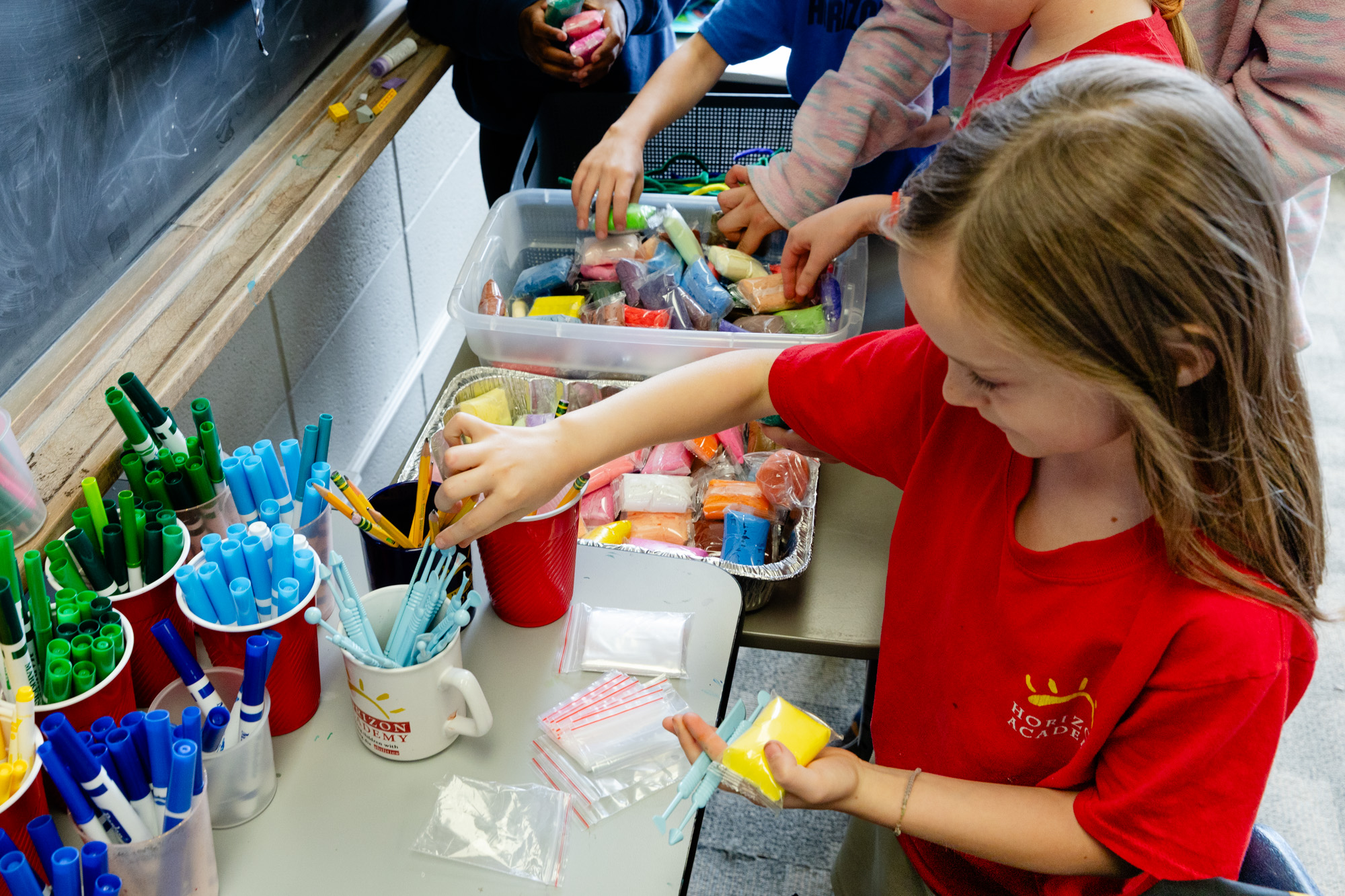 Lower school students creating projects during a hands-on classroom activity.