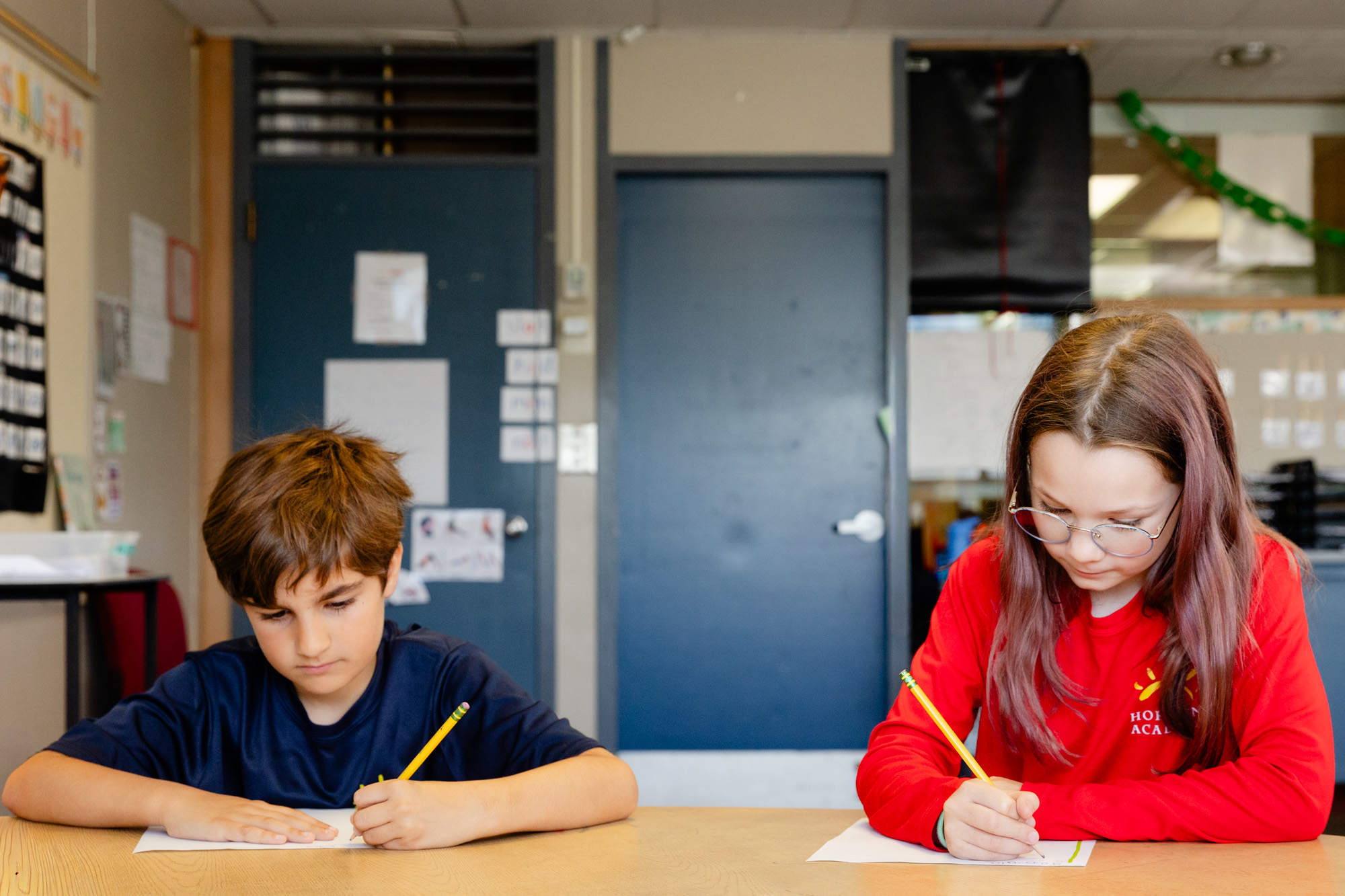 Lower school students working together on a classroom activity.