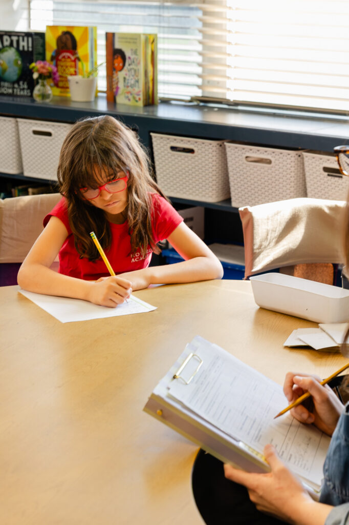 Lower school student completing a classroom assignment independently.