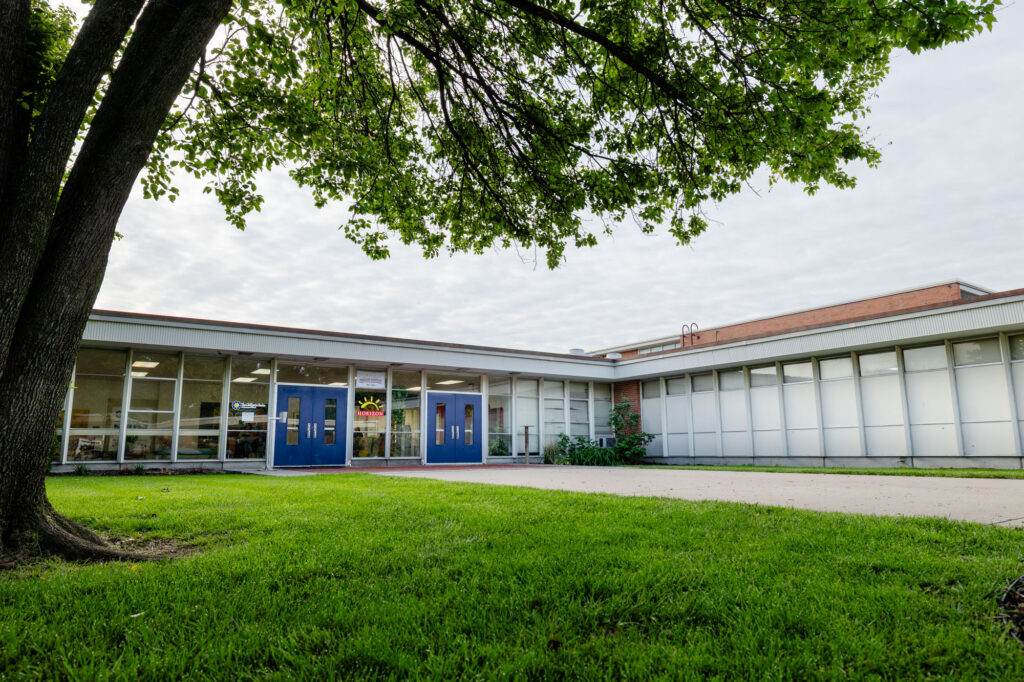 Exterior view of a Horizon Academy campus building with a grassy lawn.