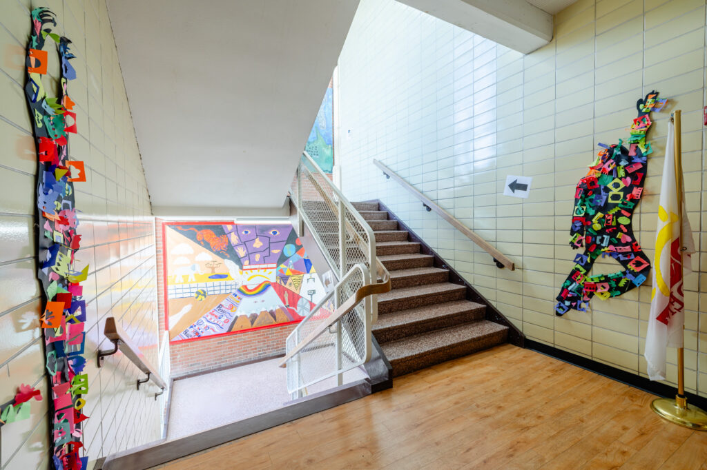 Stairwell with colorful wall mural inside Horizon Academy.
