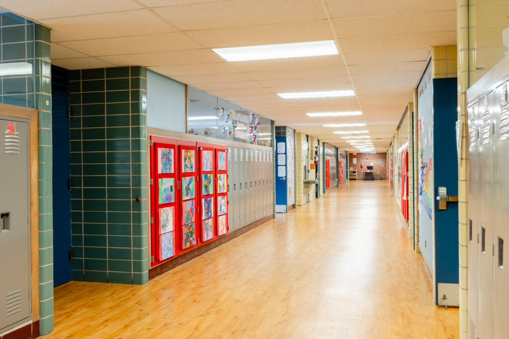 Hallway with colorful lockers and polished floors at Horizon Academy.