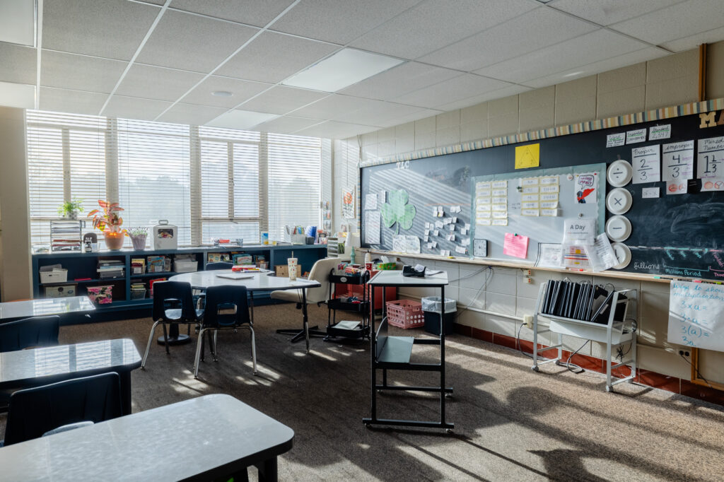 Modern classroom with tables, chairs, and natural light at Horizon Academy.