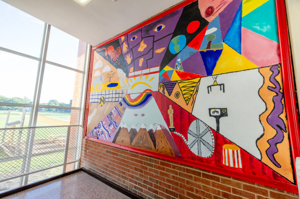 Colorful mural displayed along a hallway wall at Horizon Academy.