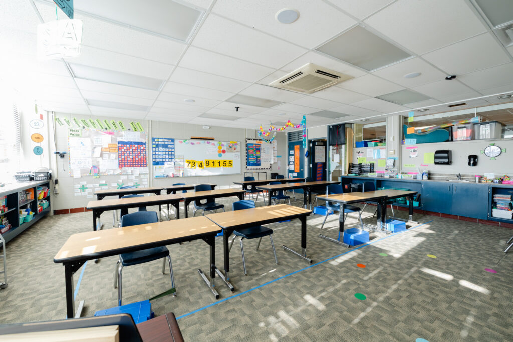 Bright classroom with tables, chairs, and collaborative learning spaces at Horizon Academy.