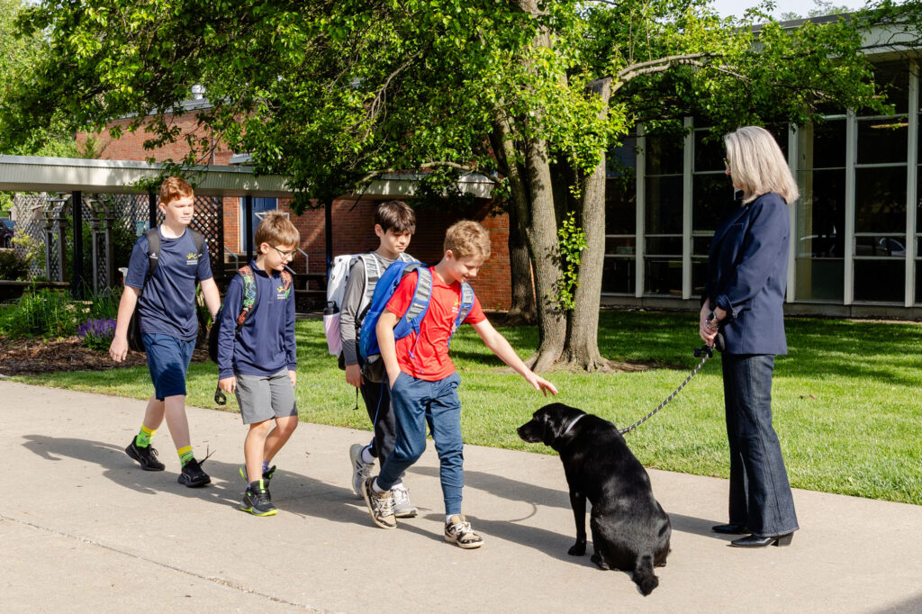 Students and staff walking together outdoors during a morning meeting at Horizon Academy.