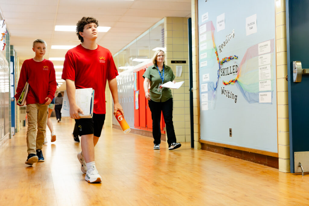 Students and staff walking through a hallway at Horizon Academy.