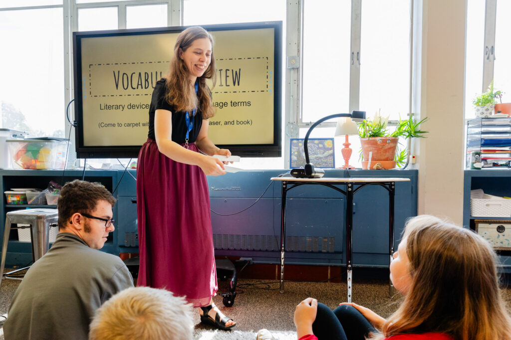 Teacher presenting a lesson to middle school students in the classroom.
