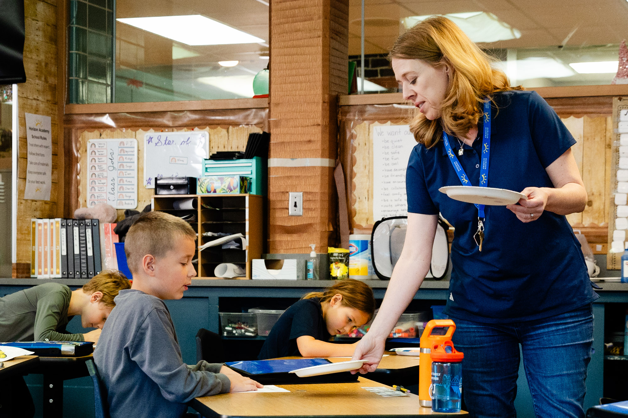 Occupational therapist working one-on-one with a student during a classroom therapy session.
