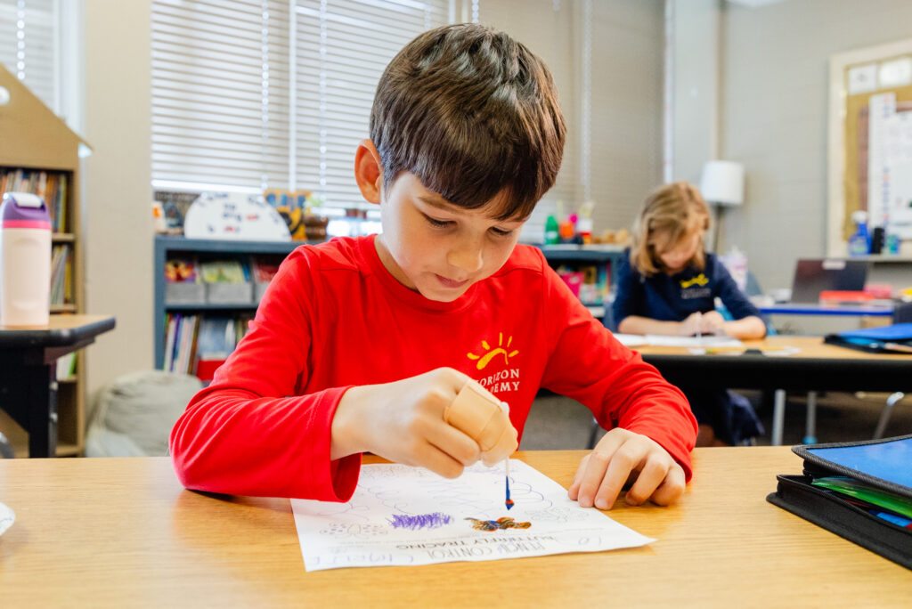 Student completing a fine motor skills activity during an occupational therapy session.