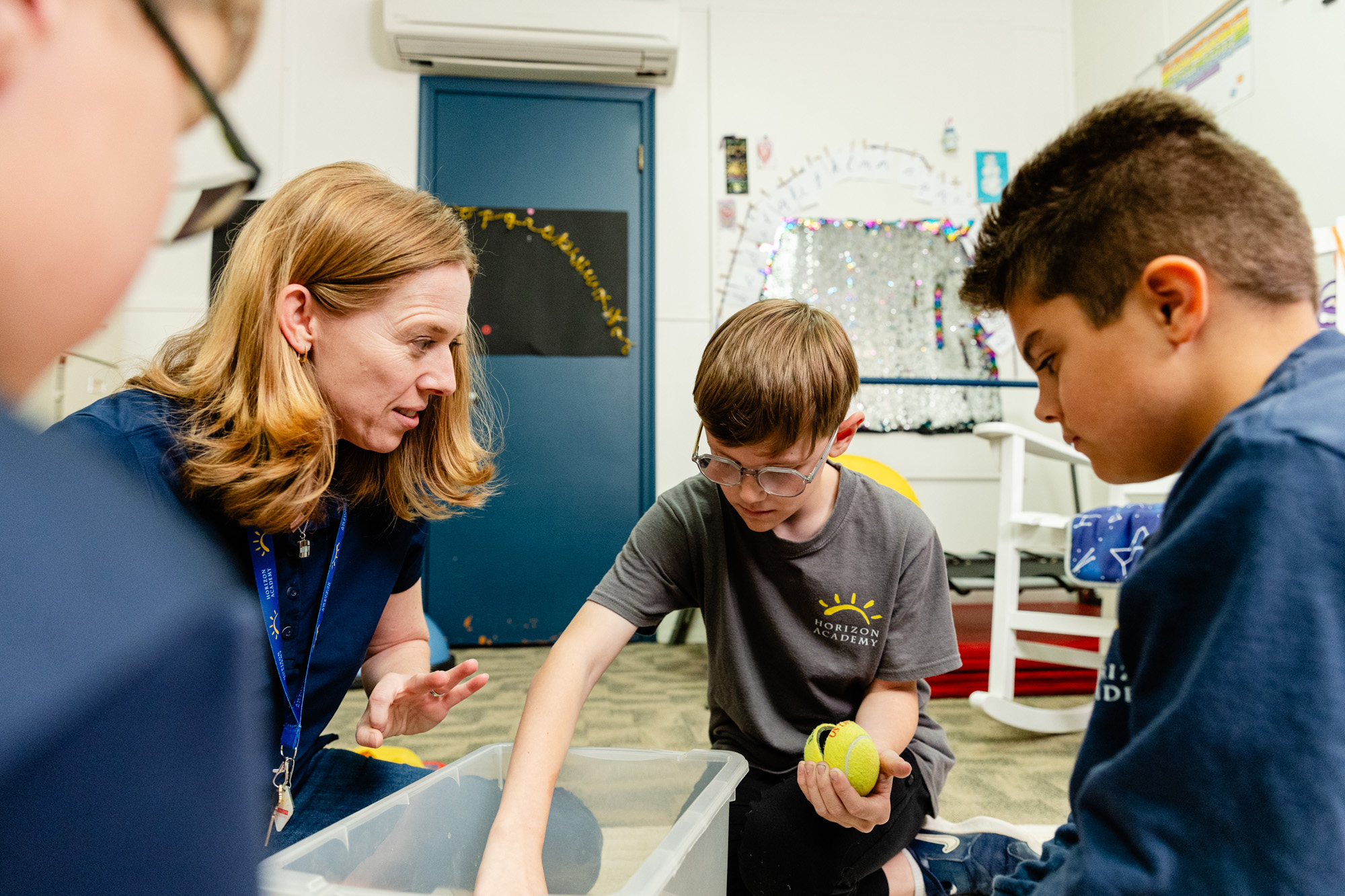 Occupational therapist working one-on-one with a student during a therapy session.