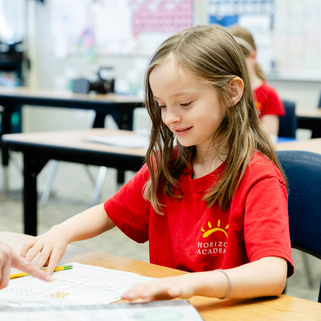 Student completing a classroom assignment during an independent learning activity.