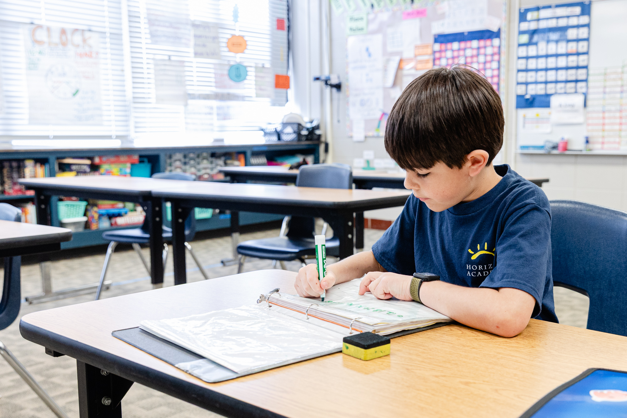 Student working independently during a classroom lesson at Horizon Academy.