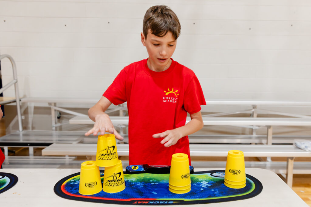 Student participating in a hands-on classroom learning activity with educational materials.