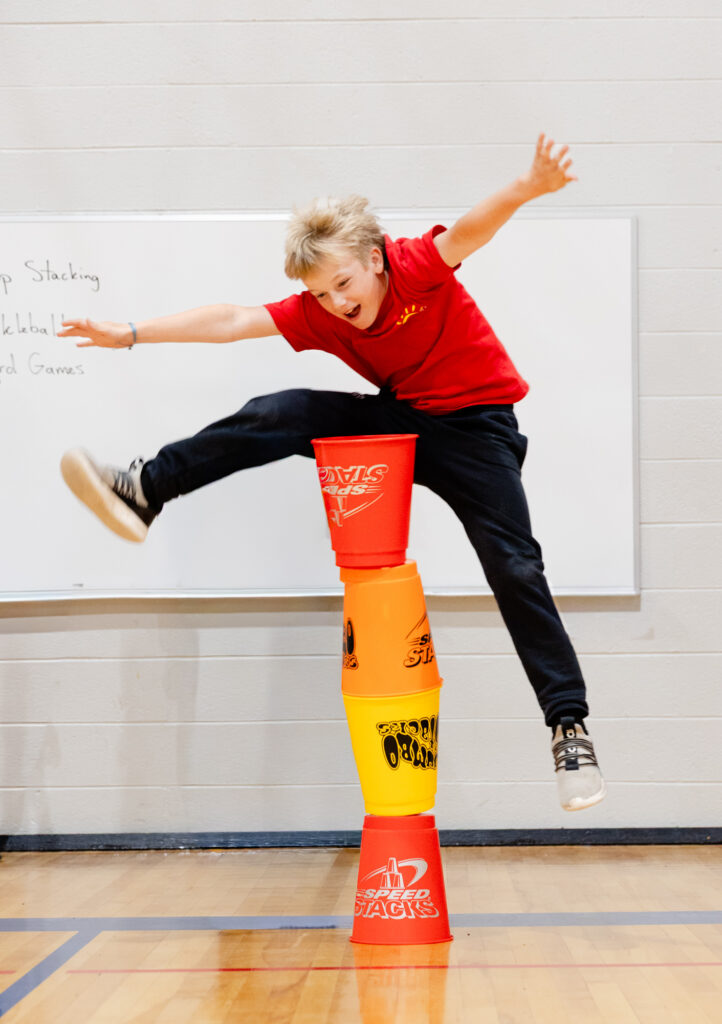 Student balancing on classroom equipment during a movement activity.