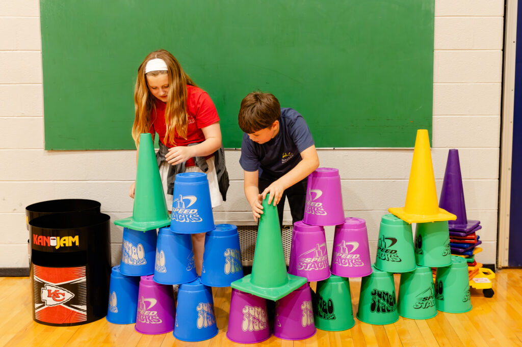 Students building with colorful foam blocks during a hands-on learning activity.
