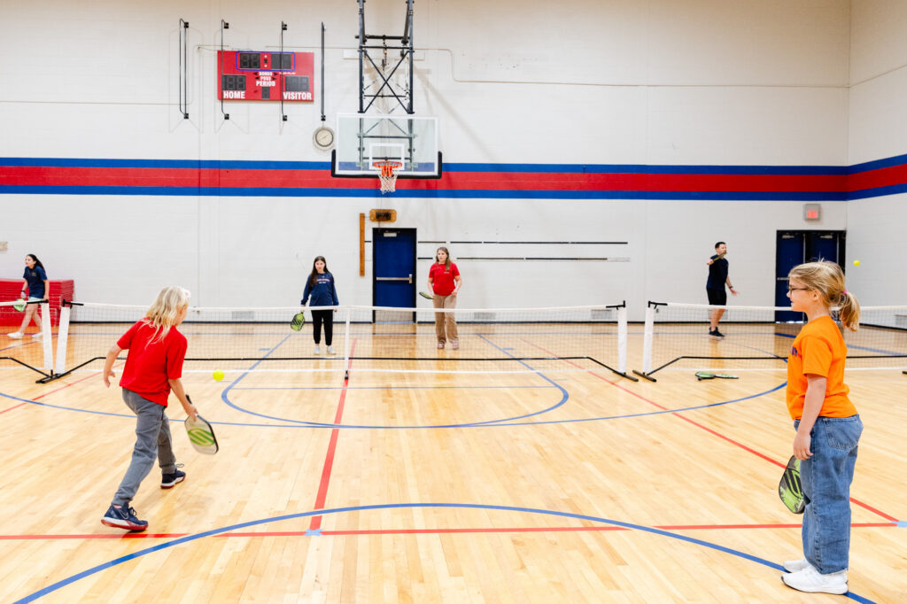 Students participating in a physical education activity in the Horizon Academy gymnasium.