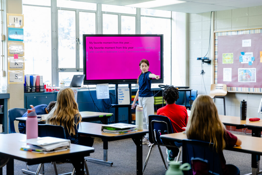 Students participating in a social-emotional learning lesson using a classroom display.
