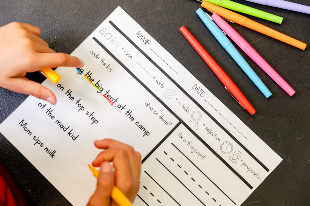 Speech therapy worksheets and learning materials on a classroom table.