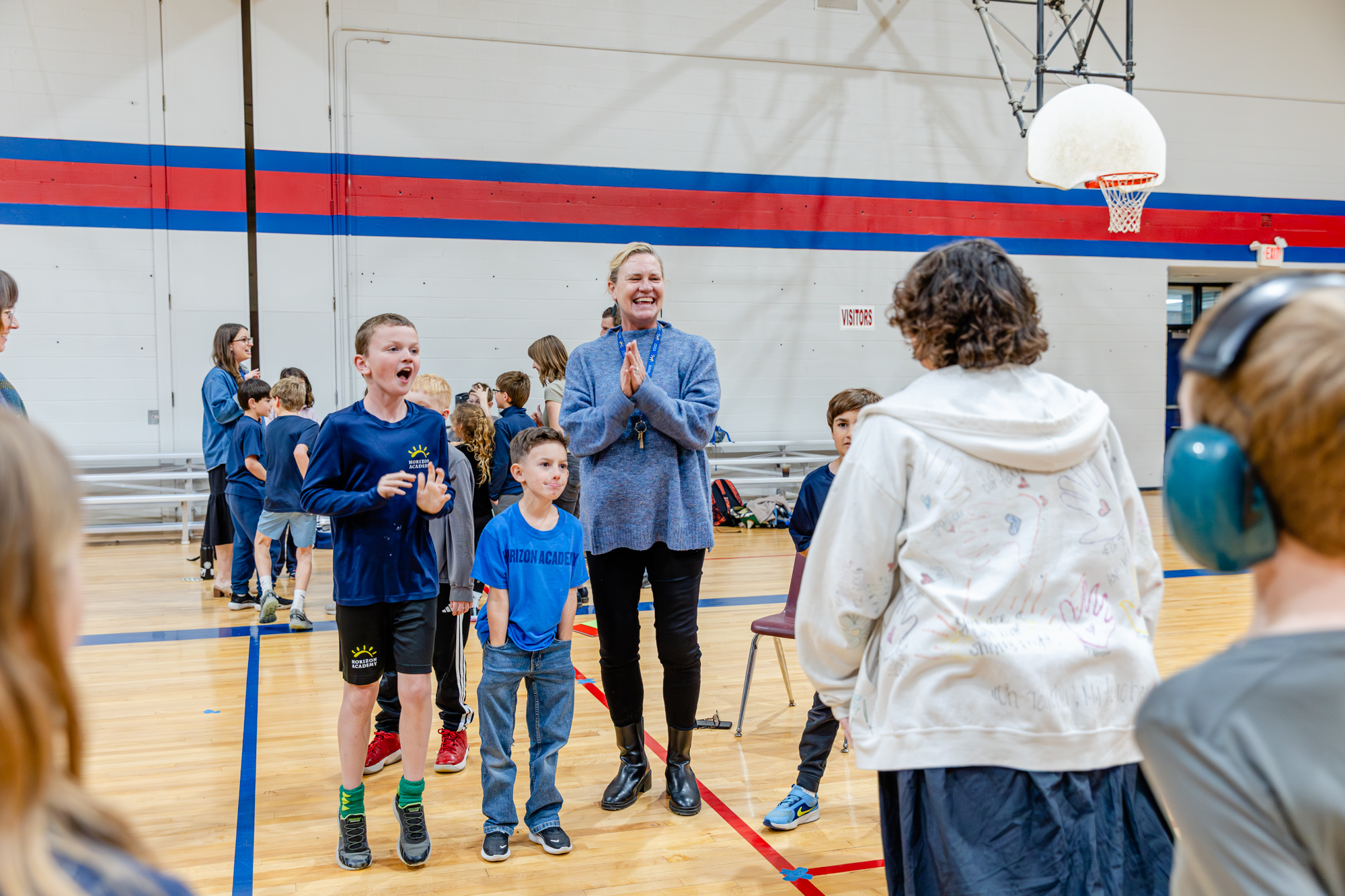 Students participating in a group activity with staff support at Horizon Academy.
