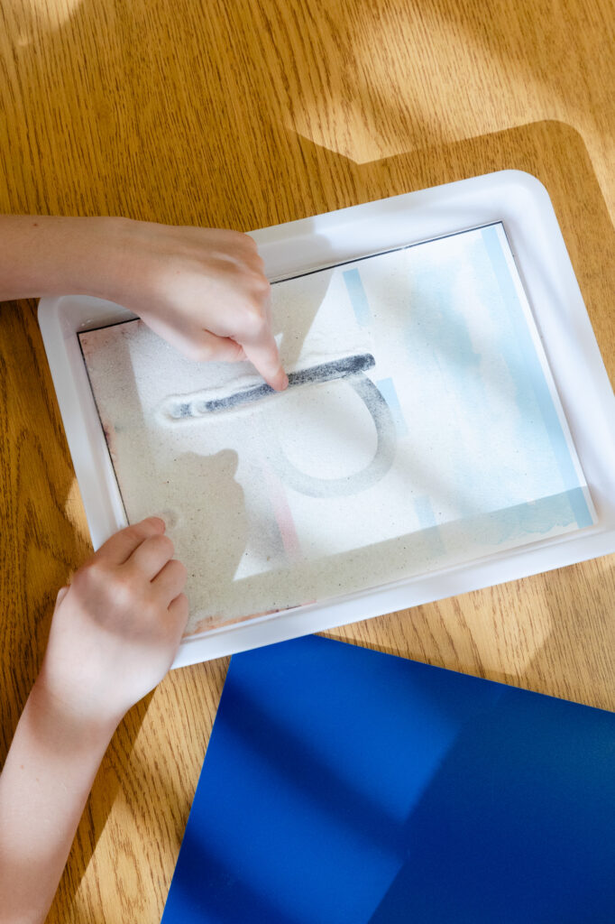 Student using a light table for a hands-on learning activity during a Horizon Academy summer program.