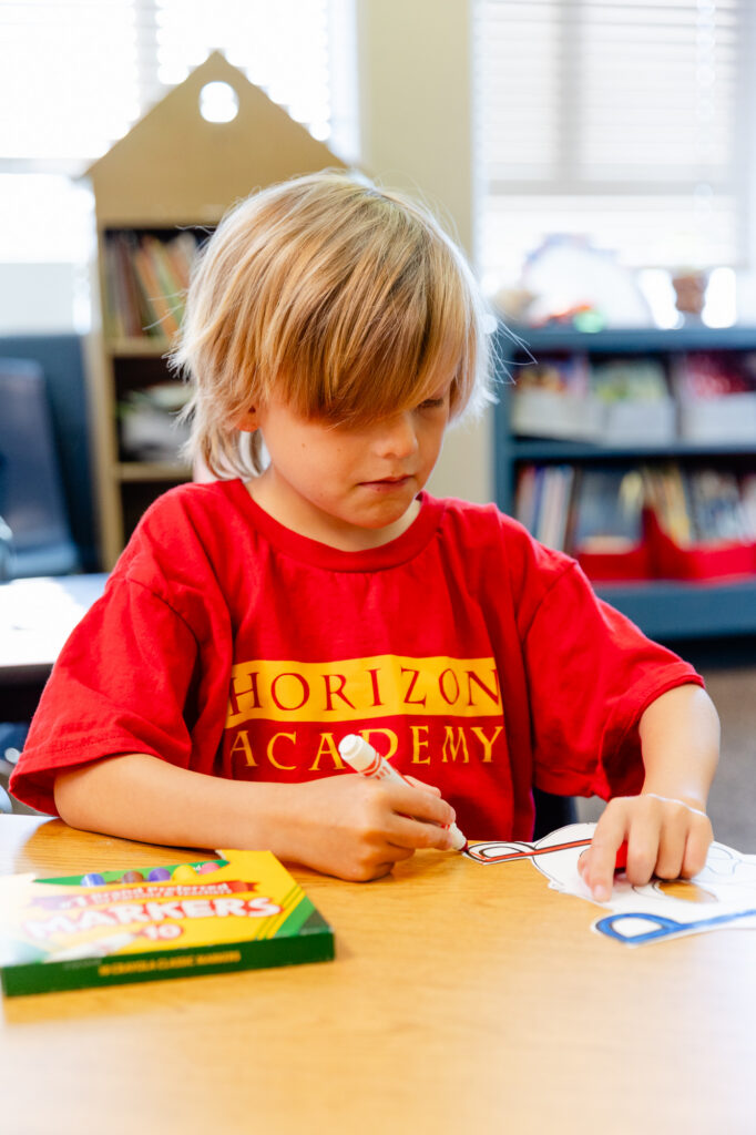 Student participating in a hands-on literacy activity during a Horizon Academy summer program.
