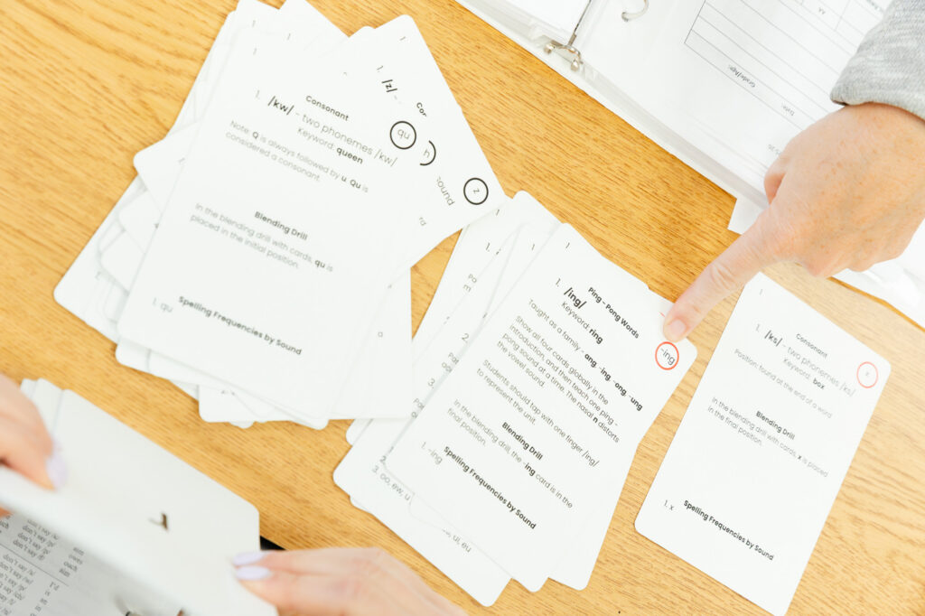 Teacher training materials and printed handouts on a classroom table.