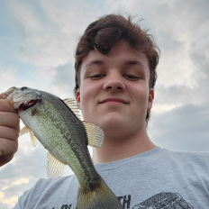 Teenage boy holding a fish.