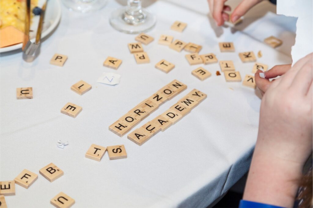 An image of a table with Horizon Academy spelled out with wooden blocks taken last year at Brilliantly Wired 2025.